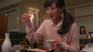 A woman drinking alone at a soba restaurant