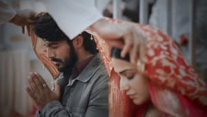 A priest blesses Sneha and Siddhu